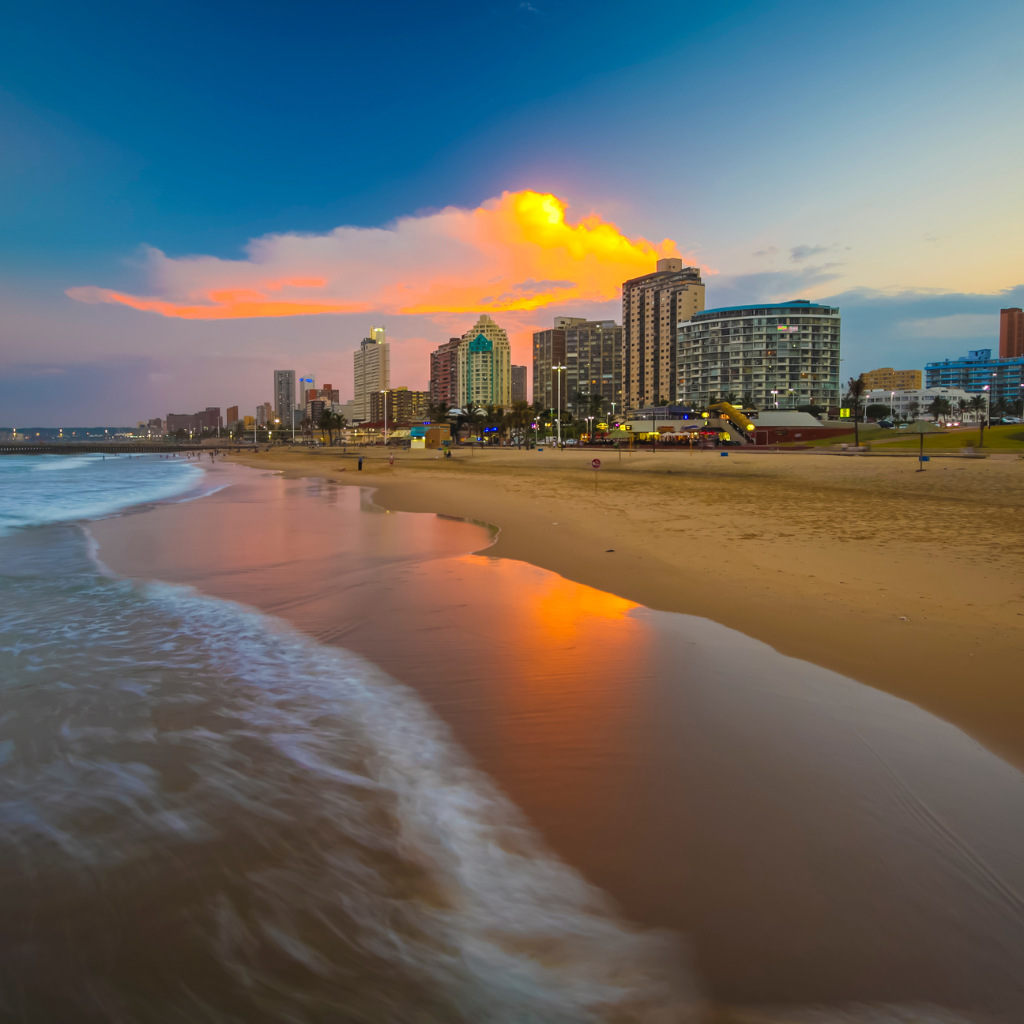 Beachfront US city skyline at sunset.